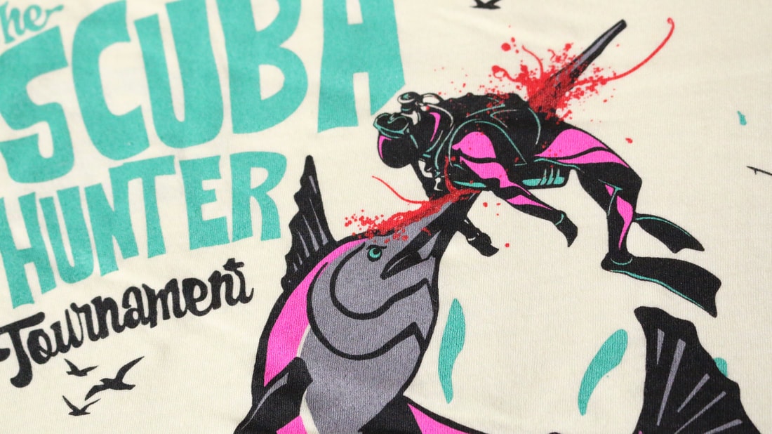 Scuba Hunter Tournament tee detail — cream colourway